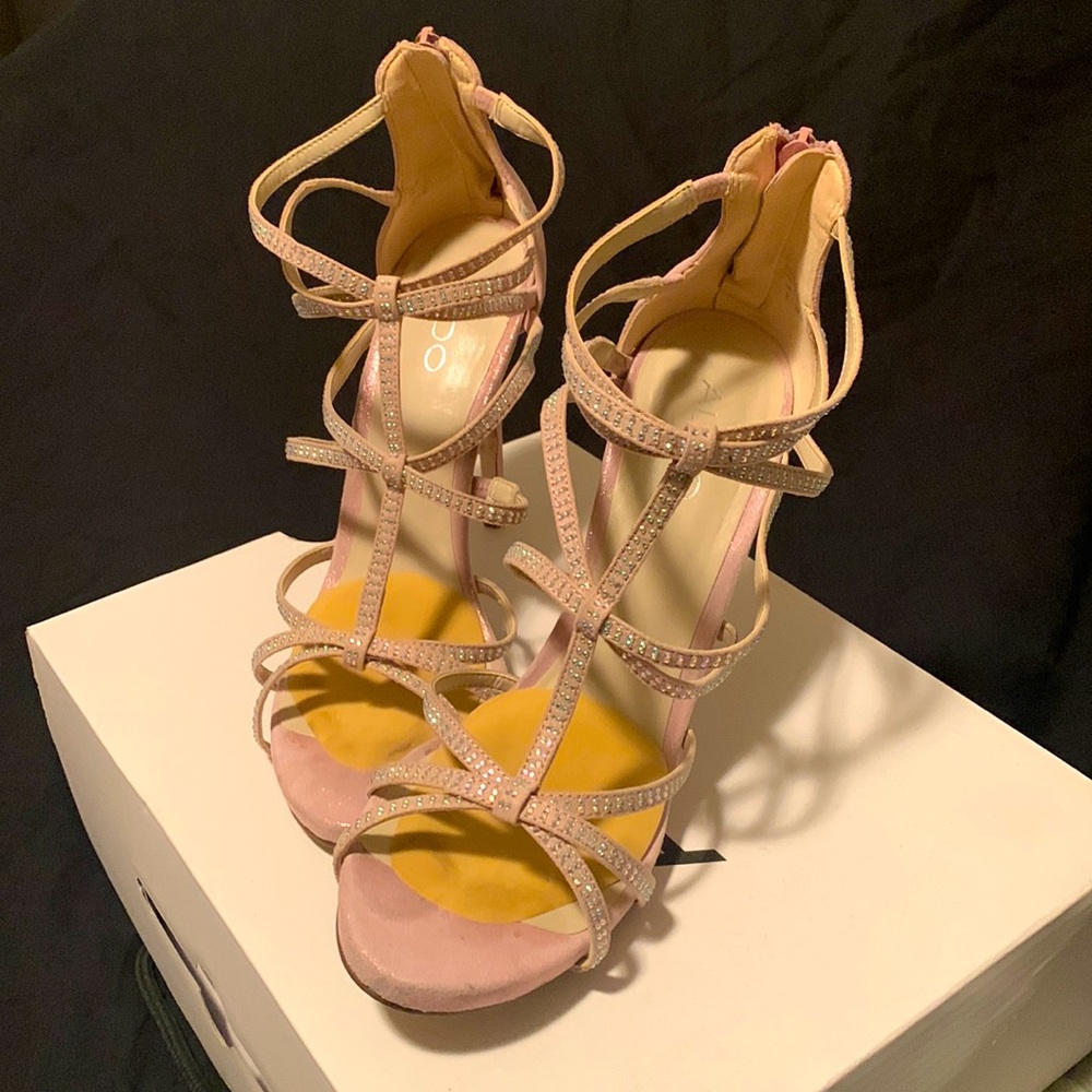 Pink strappy suede heels.